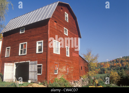 A three story red barn in autumn in VT Stock Photo