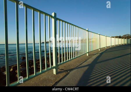 Fence lines the Cliff Walk, Cliffside Mansions of Newport Rhode Island Stock Photo