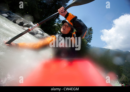 Whitewater kayaker turning into an eddy on Inn River near Pfunds, Austria Stock Photo