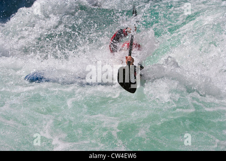 Whitewater kayaker surfacing after running drop on Inn River near Pfunds, Austria Stock Photo