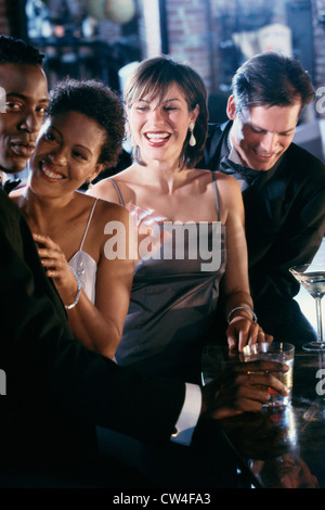 Two young couples together in a bar Stock Photo