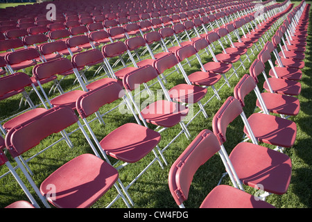 Rows of empty white chairs in grassy field in Washington, DC Stock Photo