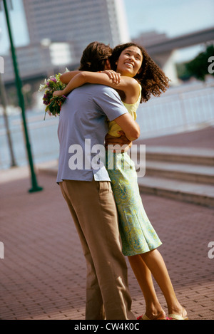 Side profile of a young man embracing a young woman Stock Photo - Alamy