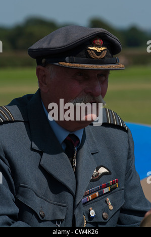 Man dressed in WWII RAF uniform, with cap, wings, moustache, hands ...