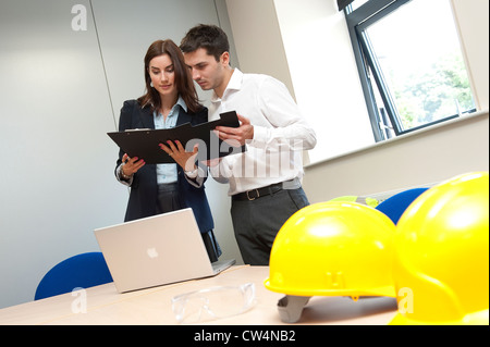 construction workers in office meeting Stock Photo