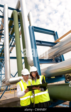 technicians working in industrial chemical plant, norfolk, england Stock Photo