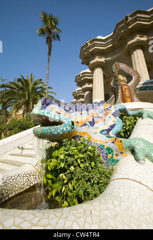 A colored mosaic dragon fountain with colored ceramic tile stands guard over Antoni Gaudi's Parc Guell, Barcelona, Spain Stock Photo