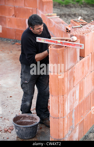 Mason working on site alone Stock Photo