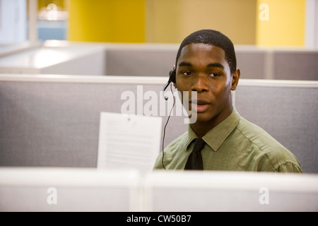 Young man using headset in an office Stock Photo