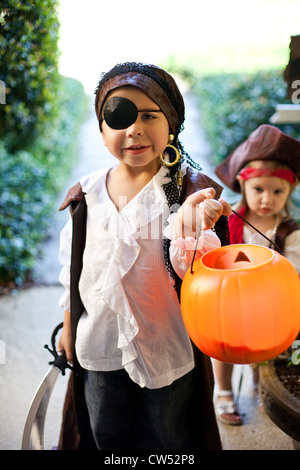 Boy and girl playing Trick Or Treat Stock Photo