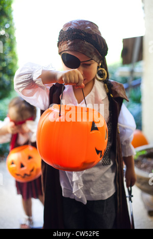 Boy and girl playing Trick Or Treat Stock Photo