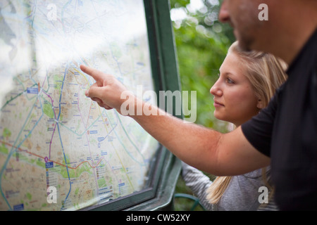 France, Ile-De-France, Paris, Man observing metro map with teenage daughter Stock Photo