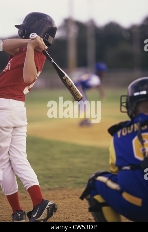 Three boys playing baseball Stock Photo