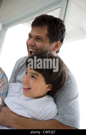 Side profile of a boy playing with his father Stock Photo