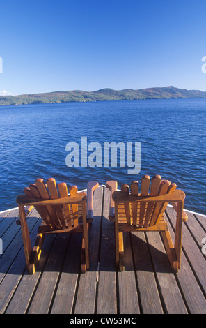 Two Adirondack chairs on a deck overlooking Lake George, NY Stock Photo