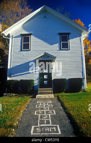 Small schoolhouse with hopscotch pattern on sidewalk, Monterey, MA Stock Photo