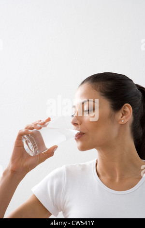 Close-up of a young woman drinking water Stock Photo