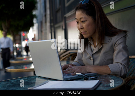 Businesswoman using a laptop Stock Photo
