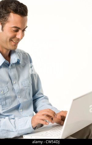 Businessman using a laptop and smiling Stock Photo