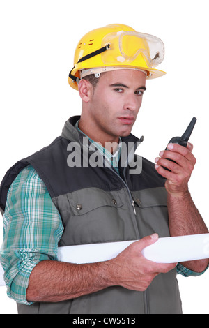Worker communicate using radio to control loading containers at port ...