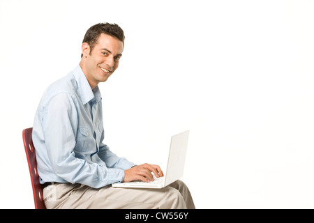 Businessman using a laptop and smiling Stock Photo