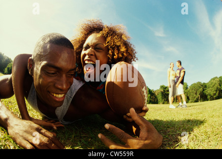 Close-up of a young couple playing football Stock Photo