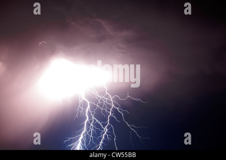 Spectacular double lightning strike from a thunderstorm cloud at night. Stock Photo