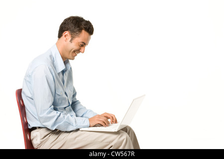 Businessman using a laptop and smiling Stock Photo