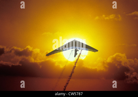 Solar Sailing Hang Gliding in sunset silhouette Stock Photo