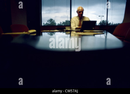 Businessman using a laptop in a conference room Stock Photo