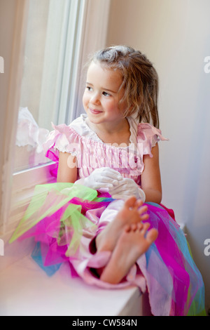 Girl looking out window Stock Photo