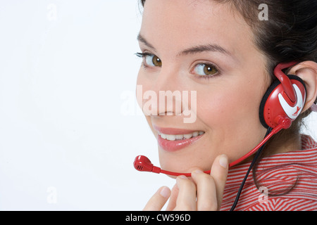 Portrait of a female customer service representative wearing a headset ...
