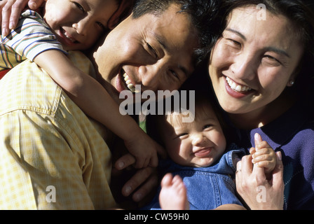 Portrait of parents with their son and daughter smiling Stock Photo - Alamy