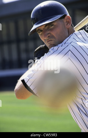 Baseball player swinging a baseball bat Stock Photo