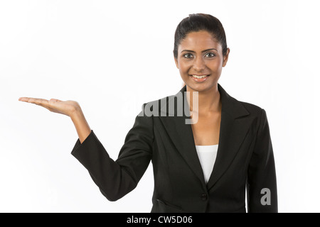 Happy Indian woman holding out her hand to show your message. Isolated on white background. Stock Photo