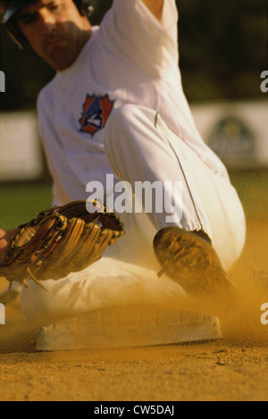 Baseball player sliding into a base Stock Photo