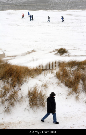 Walkers in the snow on Sylt Stock Photo
