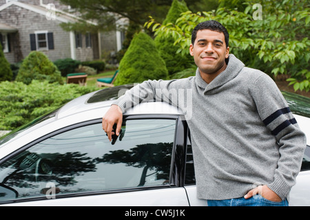 Man leaning against a car, Chatham, Cape Cod, Massachusetts, USA Stock Photo
