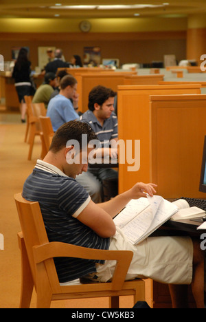 College students working on assignments in the university's library Stock Photo
