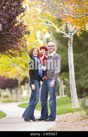 Family smiling in a park Stock Photo