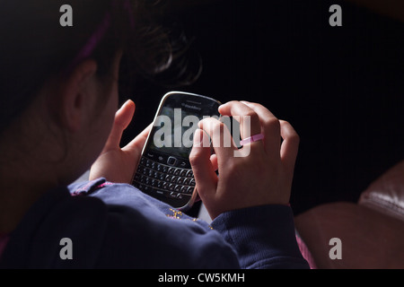 Child texts on  a Blackberry Smart Phone Stock Photo