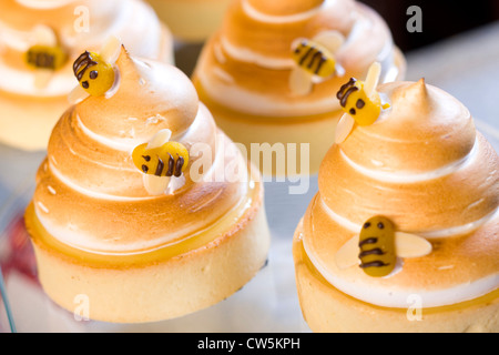 Close-up of lemon meringue tarts with marzipan bees Stock Photo