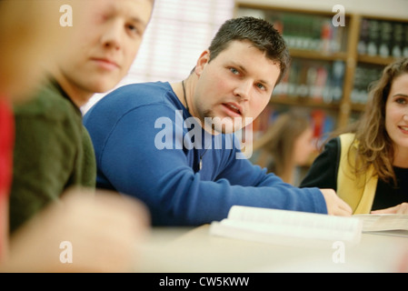 University students discussing while working on a project Stock Photo