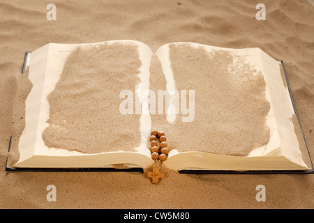 Loss of faith forgotten words of Bible religion concept on desert in sand Stock Photo