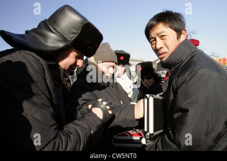 Beijing tourists are buying from a dealer on the street flying Stock Photo