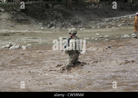 A US Army Sgt. wades through a river to see if it was able to be crossed August 14, 2011 in Palau, Paktika province, Afghanistan. Stock Photo