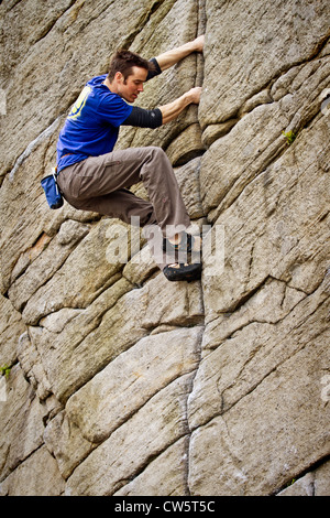 Tom Randall rock climbs a crack at Burbage in Sheffield near Stanage on the Peak District National Park Derbyshire, England, UK Tom Randall rock climbs a crack at Burbage in Sheffield near Stanage on the Peak District National Park Derbyshire, England, UK