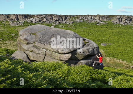 Tom Randall rock climbs a crack at Burbage in Sheffield near Stanage on the Peak District National Park Derbyshire, England Tom Randall rock climbs a crack at Burbage in Sheffield near Stanage on the Peak District National Park Derbyshire, England