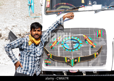 Proud truck (lorry) driver in front of his truck (lorry) on the Leh-Manali Highway Ladakh, India Stock Photo