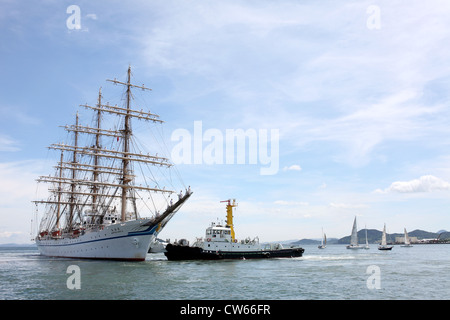 Big sailing ship and  sailor men docked at the port Stock Photo